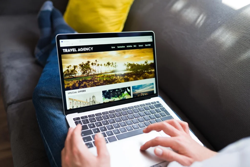 Guest researching and booking a vacation rental through an OTA on a laptop - Zeevou